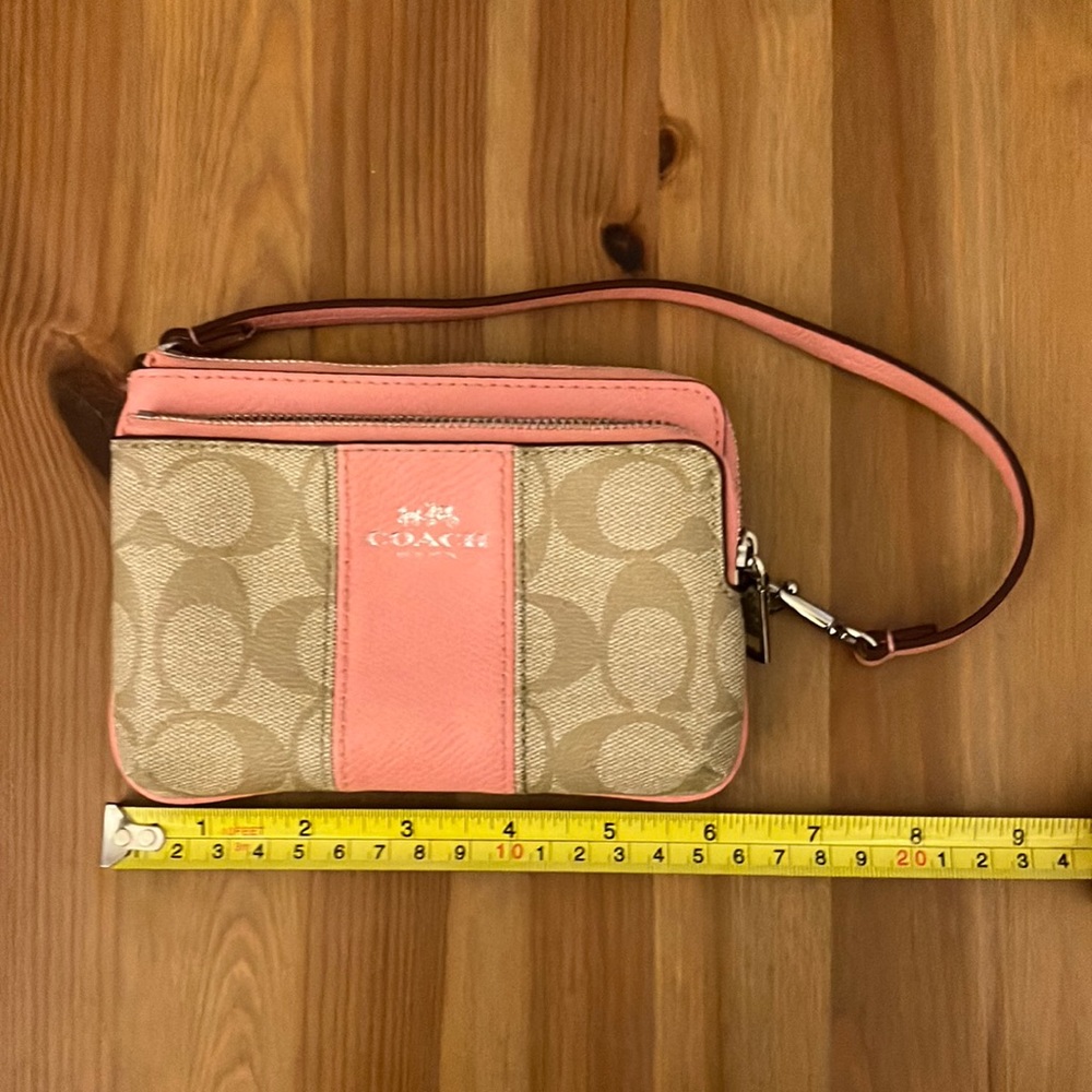 Pink and tan signature Coach wristlet